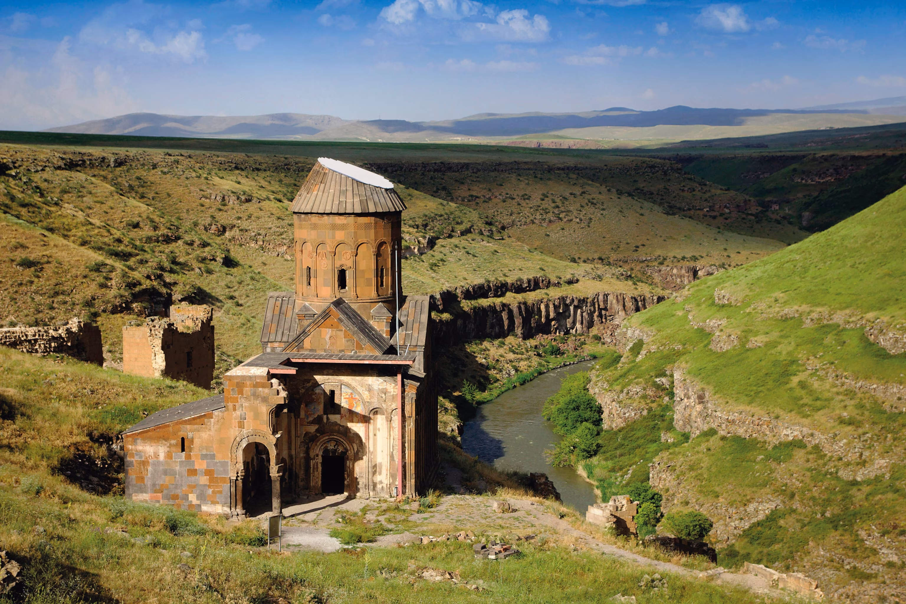 An ancient church set against a mountainous landscape